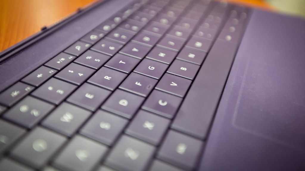 An engineer reviewing terminal output on a laptop at a desk.